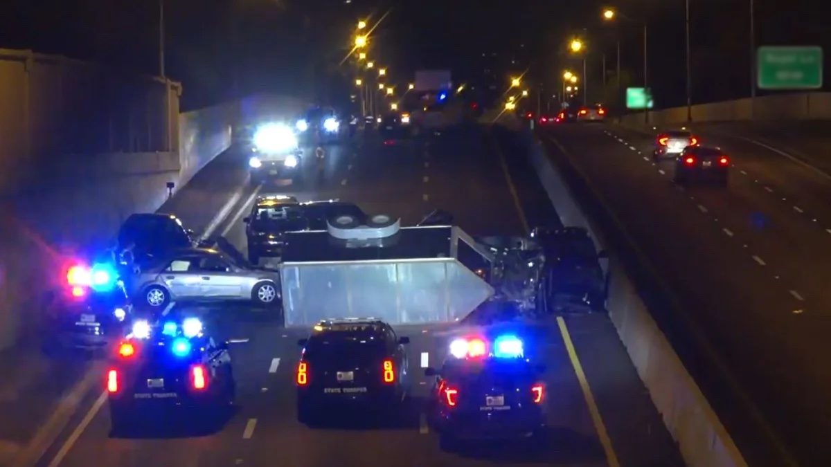 State troopers responding to a multi-vehicle collision on a highway at night